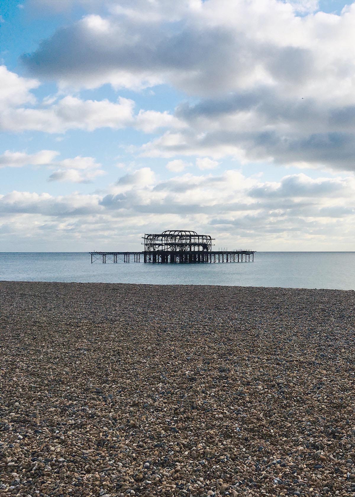 Brighton old pier on a partly cloudy day.